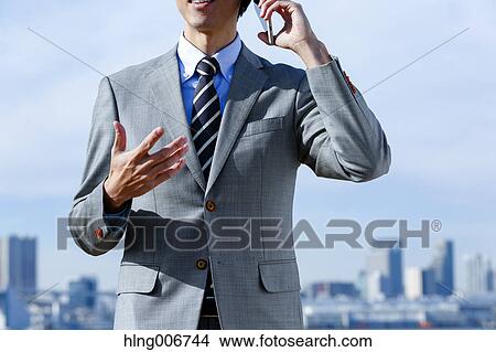 Japanese businessman on the phone downtown Tokyo, Japan View Large Photo Image Picture - Japanese businessman on the phone downtown Tokyo, Japan. Fotosearch