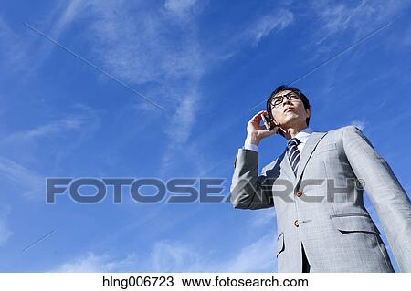 Japanese businessman on the phone downtown Tokyo, Japan View Large Photo Image Stock Image - Japanese businessman on the phone downtown Tokyo, Japan. Fotosearch
