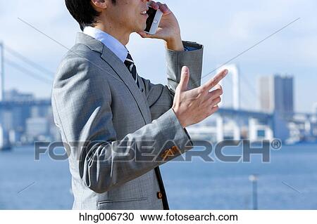 Japanese businessman on the phone downtown Tokyo, Japan View Large Photo Image Stock Image - Japanese businessman on the phone downtown Tokyo, Japan. Fotosearch