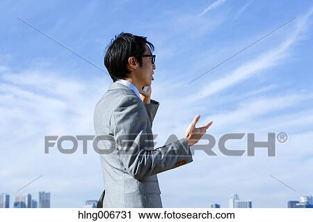 Japanese businessman on the phone downtown Tokyo, Japan View Large Photo Image Stock Image - Japanese businessman on the phone downtown Tokyo, Japan. Fotosearch