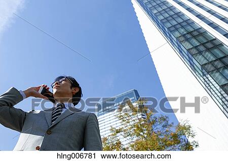 Japanese businessman on the phone downtown Tokyo, Japan View Large Photo Image Stock Image - Japanese businessman on the phone downtown Tokyo, Japan. Fotosearch