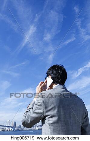 Japanese businessman on the phone downtown Tokyo, Japan View Large Photo Image Stock Photo - Japanese businessman on the phone downtown Tokyo, Japan. Fotosearch