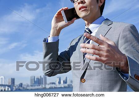 Japanese businessman on the phone downtown Tokyo, Japan View Large Photo Image Stock Photo - Japanese businessman on the phone downtown Tokyo, Japan. Fotosearch