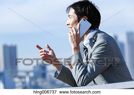 Japanese businessman on the phone downtown Tokyo, Japan View Large Photo Image Stock Photo - Japanese businessman on the phone downtown Tokyo, Japan. Fotosearch