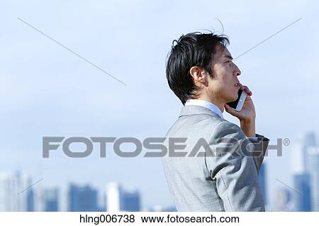 Japanese businessman on the phone downtown Tokyo, Japan View Large Photo Image Stock Photo - Japanese businessman on the phone downtown Tokyo, Japan. Fotosearch