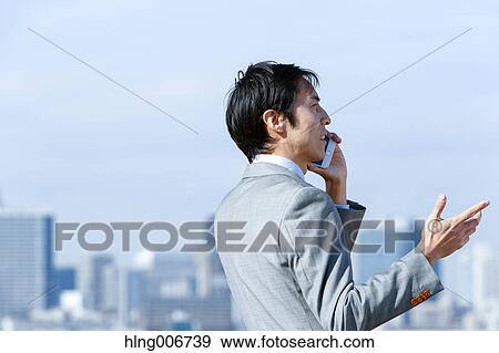 Japanese businessman on the phone downtown Tokyo, Japan View Large Photo Image Stock Photo - Japanese businessman on the phone downtown Tokyo, Japan. Fotosearch