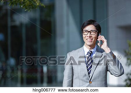Japanese businessman on the phone downtown Tokyo, Japan View Large Photo Image Stock Photo - Japanese businessman on the phone downtown Tokyo, Japan. Fotosearch