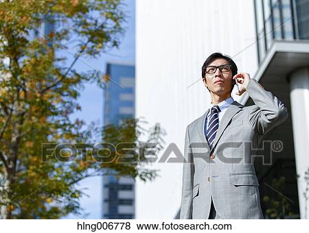 Japanese businessman on the phone downtown Tokyo, Japan View Large Photo Image Stock Photo - Japanese businessman on the phone downtown Tokyo, Japan. Fotosearch