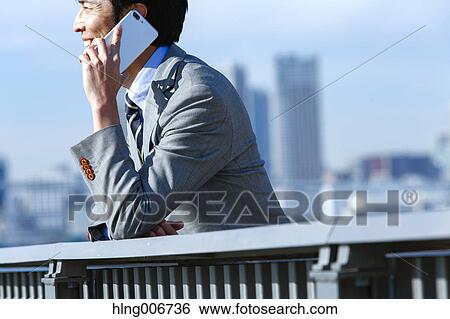 Japanese businessman on the phone downtown Tokyo, Japan View Large Photo Image Stock Photograph - Japanese businessman on the phone downtown Tokyo, Japan. Fotosearch