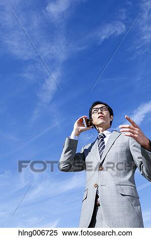 Japanese businessman on the phone downtown Tokyo, Japan View Large Photo Image Stock Photography - Japanese businessman on the phone downtown Tokyo, Japan. Fotosearch