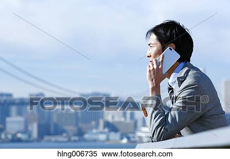 Japanese businessman on the phone downtown Tokyo, Japan View Large Photo Image Stock Photography - Japanese businessman on the phone downtown Tokyo, Japan. Fotosearch