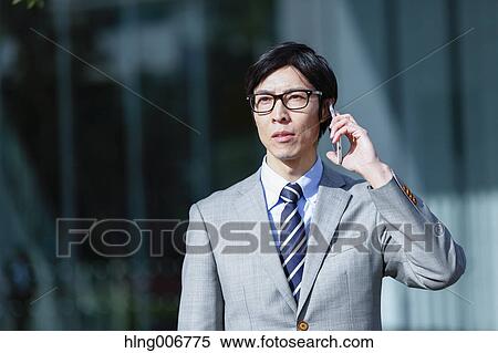 Japanese businessman on the phone downtown Tokyo, Japan View Large Photo Image Stock Photography - Japanese businessman on the phone downtown Tokyo, Japan. Fotosearch