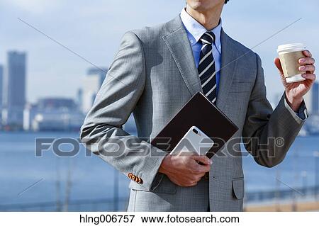 Japanese businessman with coffee downtown Tokyo, Japan View Large Photo Image Stock Photo - Japanese businessman with coffee downtown Tokyo, Japan. Fotosearch