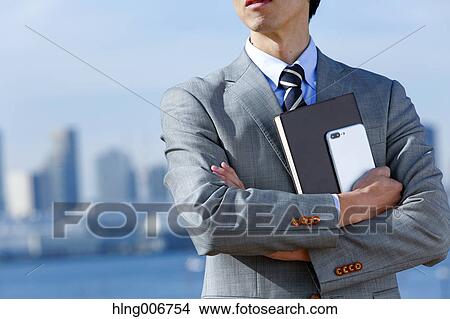 Japanese businessman with smartphone downtown Tokyo, Japan View Large Photo Image Picture - Japanese businessman with smartphone downtown Tokyo, Japan. Fotosearch