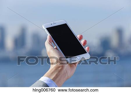 Japanese businessman with smartphone downtown Tokyo, Japan View Large Photo Image Stock Image - Japanese businessman with smartphone downtown Tokyo, Japan. Fotosearch