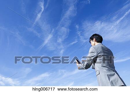 Japanese businessman with smartphone downtown Tokyo, Japan View Large Photo Image Stock Photo - Japanese businessman with smartphone downtown Tokyo, Japan. Fotosearch