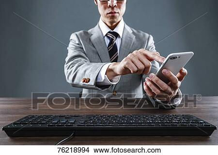 Japanese businessman working at desk View Large Photo Image Picture - Japanese businessman working at desk. Fotosearch