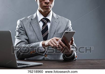 Japanese businessman working at desk View Large Photo Image Stock Image - Japanese businessman working at desk. Fotosearch