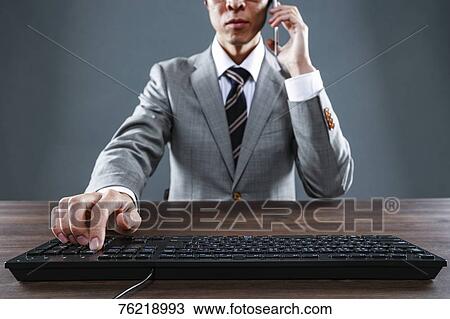 Japanese businessman working at desk View Large Photo Image Stock Image - Japanese businessman working at desk. Fotosearch