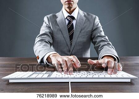 Stock Photo - Japanese businessman working at desk. Fotosearch