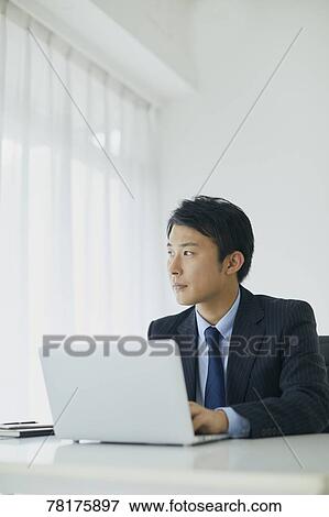 Stock Photo - Japanese businessman working. Fotosearch