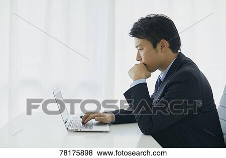 Japanese businessman working View Large Photo Image Stock Photo - Japanese businessman working. Fotosearch