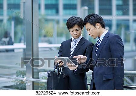Picture - Japanese businesspeople downtown Tokyo. Fotosearch