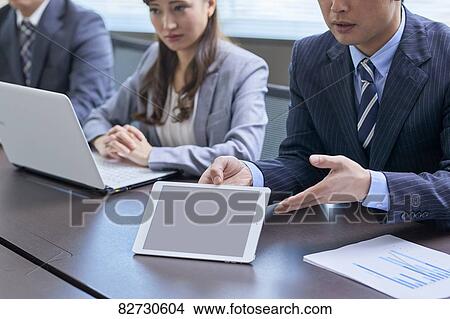 Japanese businesspeople in a meeting View Large Photo Image Picture - Japanese businesspeople in a meeting. Fotosearch