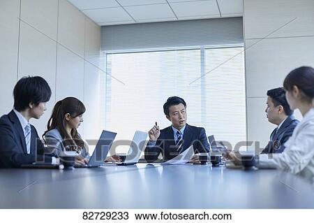 Japanese businesspeople in a meeting View Large Photo Image Stock Image - Japanese businesspeople in a meeting. Fotosearch