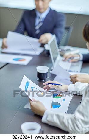 Japanese businesspeople in a meeting View Large Photo Image Stock Image - Japanese businesspeople in a meeting. Fotosearch