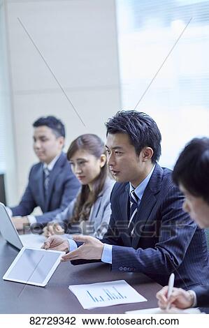 Japanese businesspeople in a meeting View Large Photo Image Stock Image - Japanese businesspeople in a meeting. Fotosearch