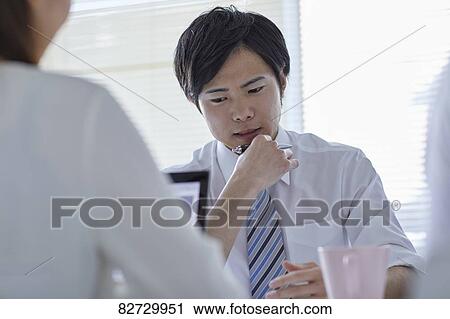 Japanese businesspeople in a meeting View Large Photo Image Stock Image - Japanese businesspeople in a meeting. Fotosearch