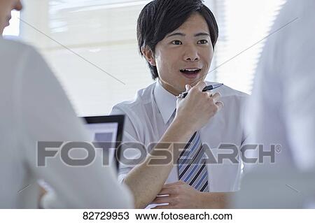 Japanese businesspeople in a meeting View Large Photo Image Stock Image - Japanese businesspeople in a meeting. Fotosearch