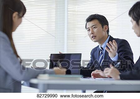 Japanese businesspeople in a meeting View Large Photo Image Stock Image - Japanese businesspeople in a meeting. Fotosearch