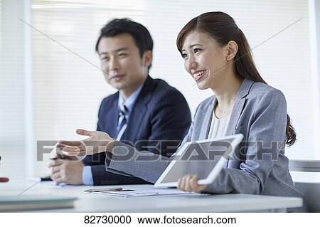 Japanese businesspeople in a meeting View Large Photo Image Stock Image - Japanese businesspeople in a meeting. Fotosearch