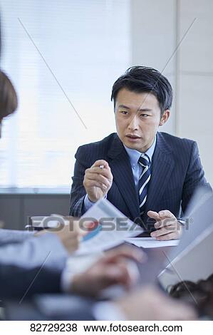 Japanese businesspeople in a meeting View Large Photo Image Stock Photo - Japanese businesspeople in a meeting. Fotosearch