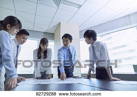 Stock Photo - Japanese businesspeople in a meeting. Fotosearch