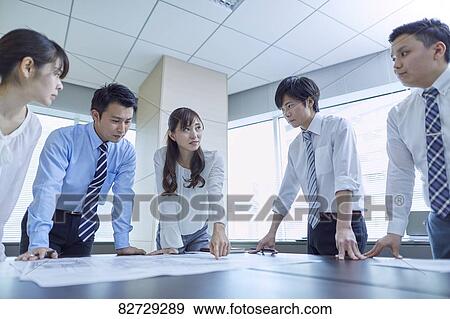 Stock Photo - Japanese businesspeople in a meeting. Fotosearch