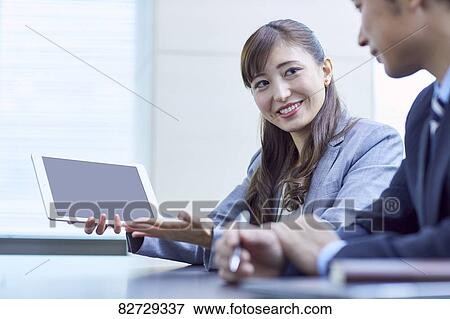 Stock Photo - Japanese businesspeople in a meeting. Fotosearch