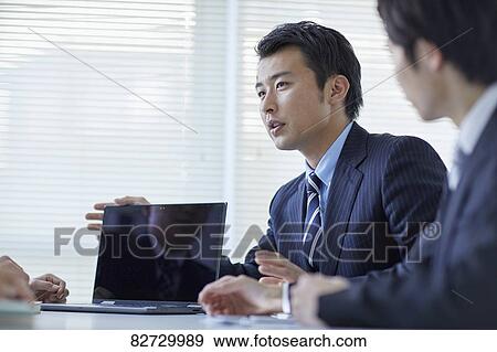 Stock Photo - Japanese businesspeople in a meeting. Fotosearch