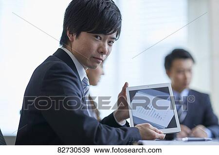 Stock Photo - Japanese businesspeople in a meeting. Fotosearch