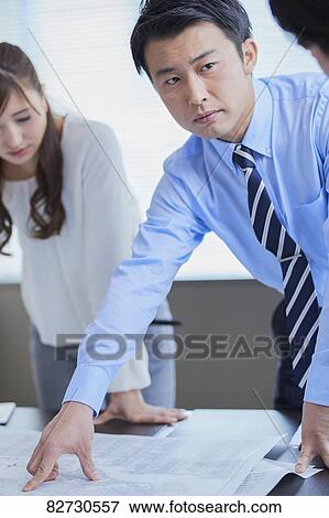Stock Photo - Japanese businesspeople in a meeting. Fotosearch