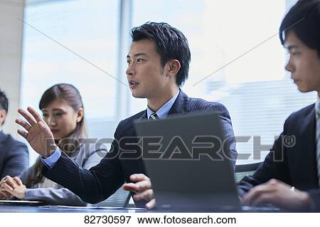 Stock Photo - Japanese businesspeople in a meeting. Fotosearch