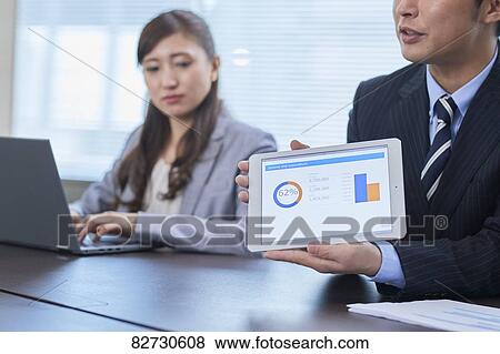 Japanese businesspeople in a meeting View Large Photo Image Stock Photo - Japanese businesspeople in a meeting. Fotosearch