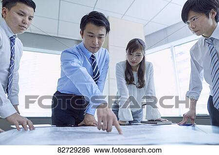 Japanese businesspeople in a meeting View Large Photo Image Stock Photograph - Japanese businesspeople in a meeting. Fotosearch