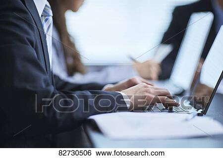 Stock Photograph - Japanese businesspeople in a meeting. Fotosearch