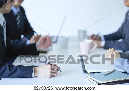 Japanese businesspeople in a meeting View Large Photo Image Stock Photograph - Japanese businesspeople in a meeting. Fotosearch