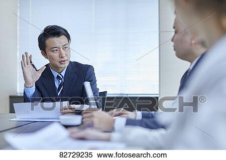 Stock Photography - Japanese businesspeople in a meeting. Fotosearch