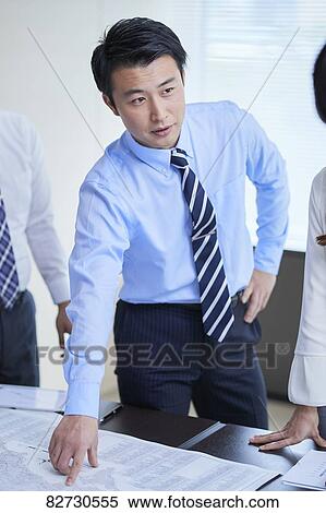 Stock Photography - Japanese businesspeople in a meeting. Fotosearch