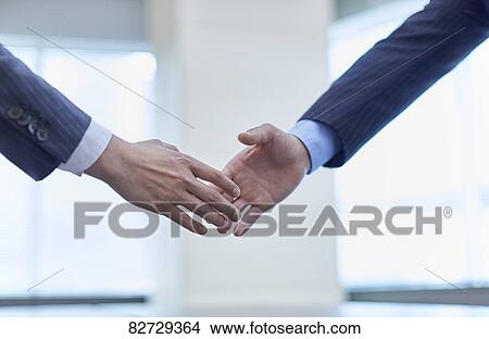 Japanese businesspeople shaking hands View Large Photo Image Picture - Japanese businesspeople shaking hands. Fotosearch